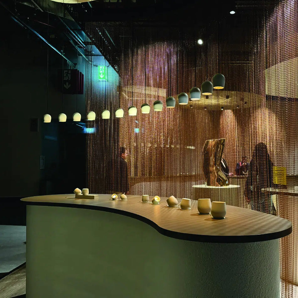 Close-up view of an adjustable pendant light in a modern dining room.