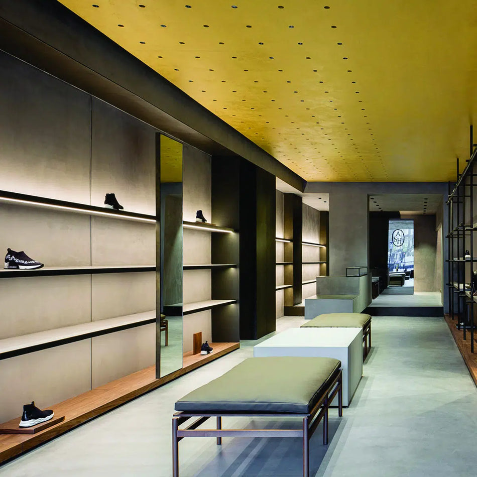 FS1267-10 Indoor Fixed Spot Light - elegantly recessed in a pristine white ceiling. The luminaire casts a crisp, focused light beam onto a surface below, illustrating its application for accentuating interior elements.